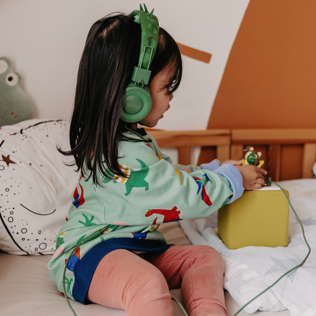 Ein Kind trägt den Alltagsbegleiter für Kinder mit Dinomotiv beim Spielen von Oktopulli